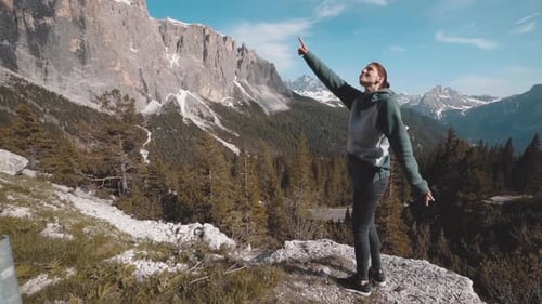 Slow Motion Shot of Happy Young Woman Walks in the Dolomites Mountains Northern Italy in the Summer
