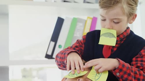 Boy Playing with Sticky Notes on Friend's Face
