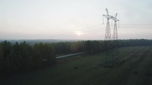 Power Line Support with High Voltage Wires in a Wooded Area