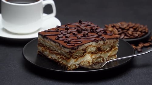 Delicious Tiramisu Cake with Coffee Beans and Cup