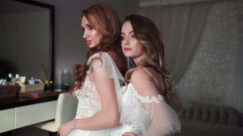 Elegant Women in White Dresses Posing Indoors