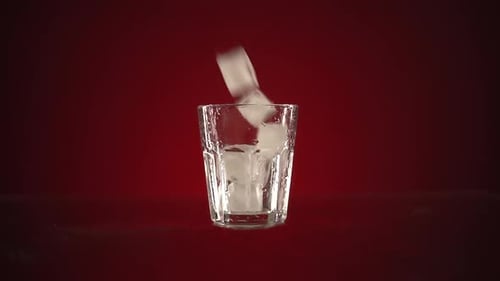 Ice Cubes Dropping Into Glass