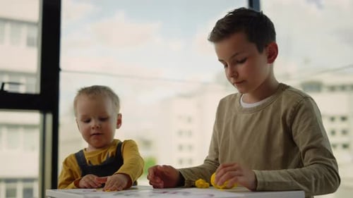 Two Boys Playing Together with Colorful Playdough