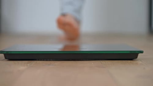 Details Female Weigh on a Scale