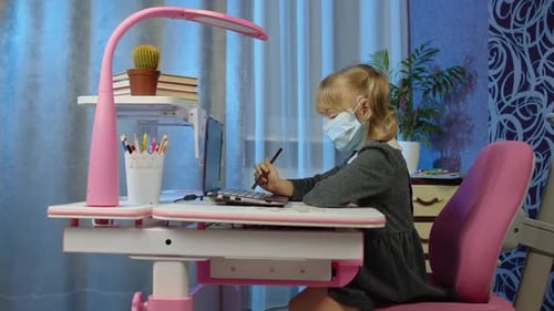 Girl with Mask Learning on Laptop at Desk