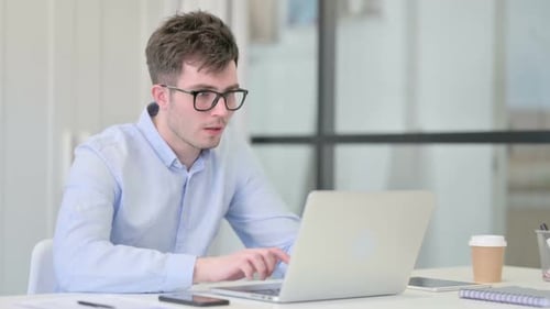 Young Adult Shocked by Computer in Office