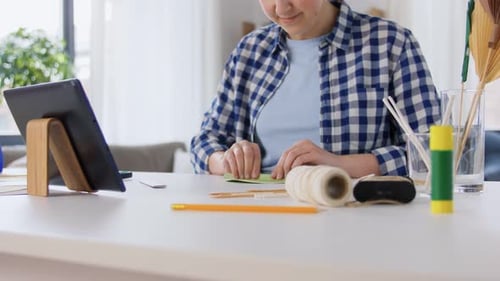 Woman Crafting Paper Decoration at Table