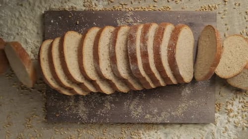 Sliced Bread Falling in Slow Motion. Top View of Wholegrain Bread Falling Down.