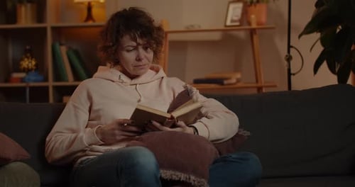 Crop View of Beautiful Woman in Hoodie Reading and Spending Free Time