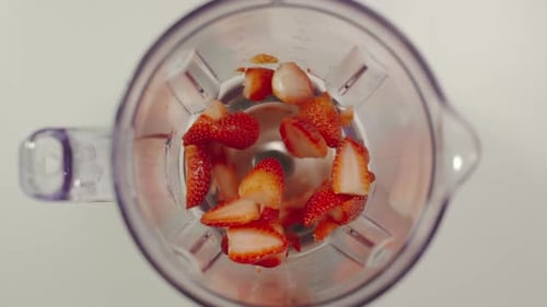 Chopped Strawberries Blended in Clear Blender