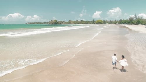 Couple Walking On A Sandy White Sandy Beach 3