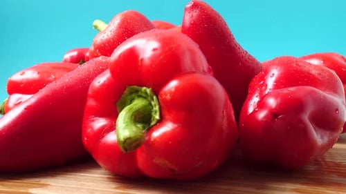 Fresh Red Bell Peppers on Wooden Board