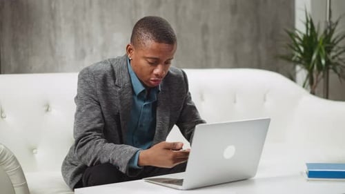 Young Adult Working Remotely on Laptop