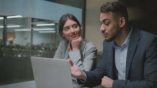 Business Colleagues Collaborating at Laptop in Modern Office