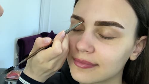 Woman Getting Eyebrows Tinted in a Home