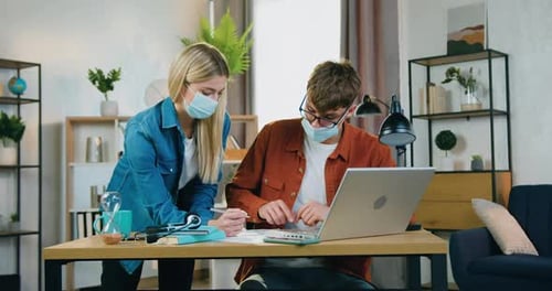 Teamwork with Laptops and Masks During Pandemic