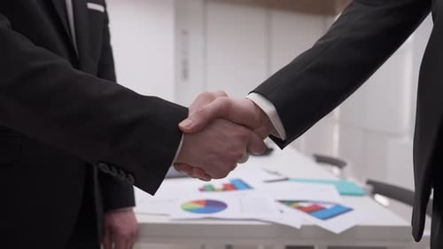 Closeup Handshake of Two Caucasian Businessmen in Office Indoors