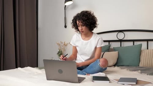 Young Adult Studying at Home with Laptop