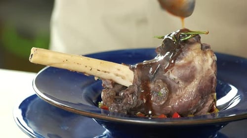 Chef Drizzling Delicious Shank With Sauce Close Up