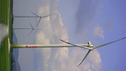 Wind Turbines in Rural Green Landscape on Cloudy Day