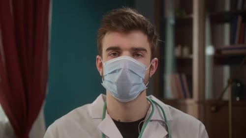 Portrait of a Handsome Smiling Doctor Close Up Young Man in Hospital Coronavirus Covid 19 Lockdown