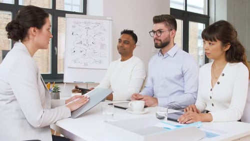 Team Members Meet in Bright Modern Office