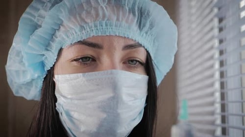 Close Up of Woman in Medical Mask and Cap