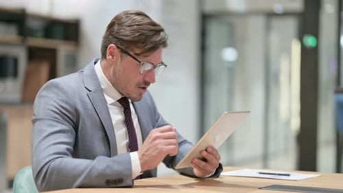 Disappointed Businessman Having Loss on Tablet in Office