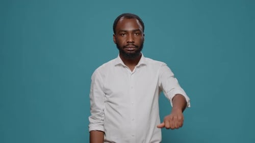 Smiling Man Gives Thumbs Up Gesture of Approval