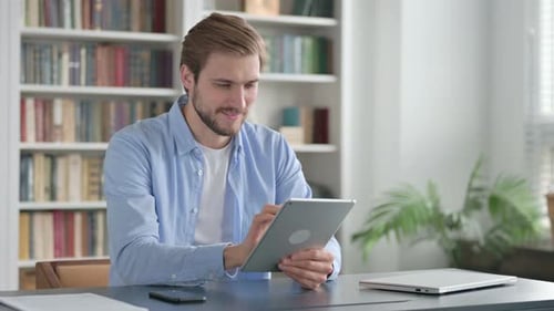 Man Using Tablet While Sitting in Office