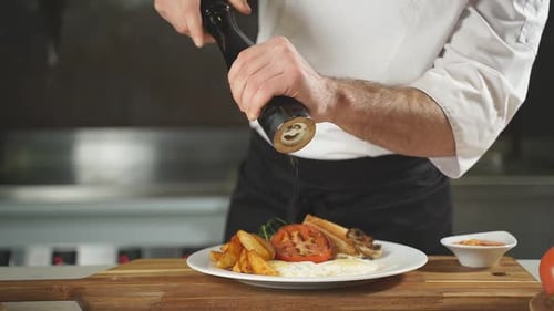 The Chef Uses a Pepper Mill to Sprinkle the Delicious Dish Before Serving