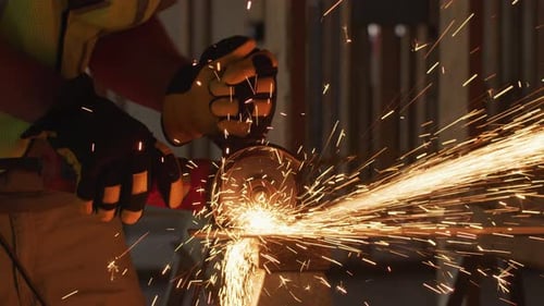 Close Up of Construction Worker Grinding Metal