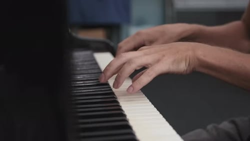 Piano Player's Hands Playing Keyboard Instrument