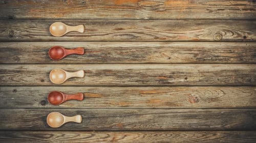 Spices Arranged in Wooden Spoons on Rustic Surface