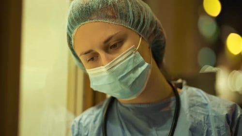 Exhausted Medical Student or Nurse Feeling Sad During Night Shift Near Hospital