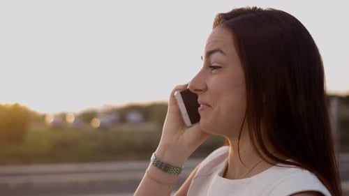 Smiling Lovely Young Girl Talking on Smartphone on Street