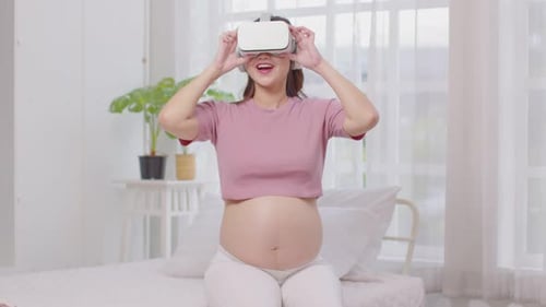 Pregnant Woman Using VR Headset at Home