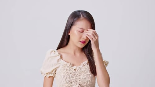 Young Woman Suffering from Headache and Pain