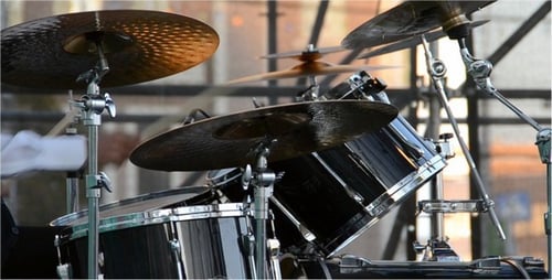 Drummer Playing Black Kit on Stage