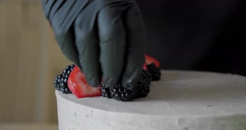 Young Woman Cooking and Decoration of Cake with Cream Decorating Red Strawberry. Close Up V2