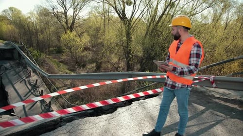 An Engineer in an Orange Vest and a Construction Control Helmet Conducts