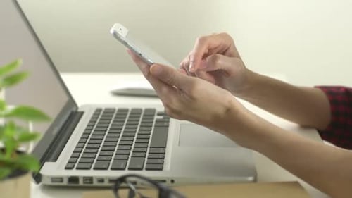 Close Up of Hands Using Cell Phone