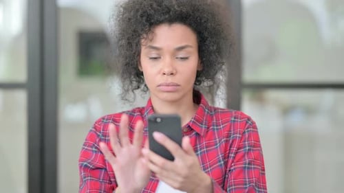 Woman Using Smartphone Indoors