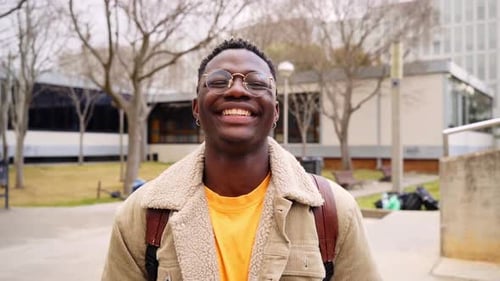 Close Up Shot of Cheerful Happy African American Teenage Boy Looking at Camera Smiling