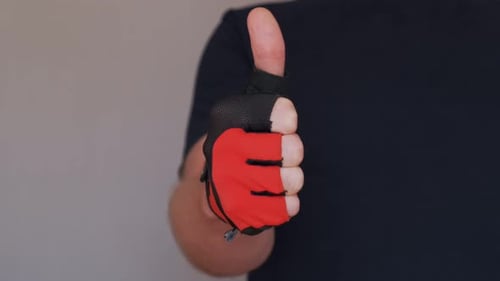 Hand With Glove Gives a Thumbs Up