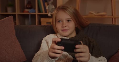 Close Up View of Joyful Young Girl Holding and Using Joystick