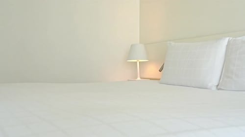 Clean Modern Hotel Room with Bed and Lamp