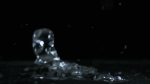 Many Drops of Water Fall on the Surface of the Water in Slow Motion Macro Shot
