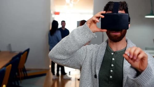 Man Uses VR Headset in Modern Office