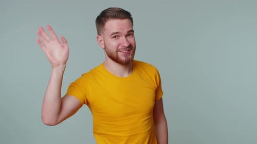 Friendly Man Waving Hello in Bright Studio